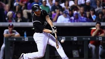 Aug 16, 2016; Denver, CO, USA; Colorado Rockies second baseman DJ LeMahieu (9) hits a two run home run in the third inning against the Washington Nationals at Coors Field. Mandatory Credit: Ron Chenoy-USA TODAY Sports