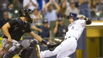 Aug 23, 2016; Milwaukee, WI, USA; Milwaukee Brewers left fielder Ryan Braun (8) scores a run behind Colorado Rockies catcher Nick Hundley (4) during the seventh inning at Miller Park. Mandatory Credit: Jeff Hanisch-USA TODAY Sports