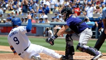 Jul 3, 2016; Los Angeles, CA, USA; Los Angeles Dodgers catcher Yasmani Grandal (9) is tagged out at home by Colorado Rockies catcher Nick Hundley (4) in the second inning of the game against the Los Angeles Dodgers at Dodger Stadium. Mandatory Credit: Jayne Kamin-Oncea-USA TODAY Sports