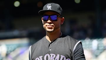 Sep 5, 2016; Denver, CO, USA; Colorado Rockies right fielder Carlos Gonzalez (5) walks back to the dugout second inning against the San Francisco Giants at Coors Field. Mandatory Credit: Ron Chenoy-USA TODAY Sports