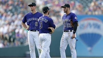 Sep 4, 2016; Denver, CO, USA; Colorado Rockies second baseman DJ LeMahieu (9) and shortstop Daniel Descalso (3) and third baseman Nolan Arenado (28) talk during a stoppage of play in the eighth inning against the Arizona Diamondbacks at Coors Field. Mandatory Credit: Isaiah J. Downing-USA TODAY Sports