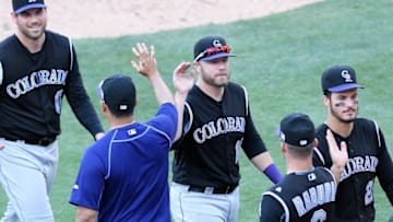 Sep 11, 2016; San Diego, CA, USA; Colorado Rockies first baseman Mark Reynolds (center) and teammates celebrate a 3-2 win over the San Diego Padres at Petco Park. Mandatory Credit: Jake Roth-USA TODAY Sports