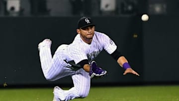 Aug 19, 2016; Denver, CO, USA; Colorado Rockies left fielder Gerardo Parra (8) dives to catch a hit in the tenth inning against the Chicago Cubs at Coors Field. The Rockies defeated the Cubs 7-6 in 11 innings. Mandatory Credit: Ron Chenoy-USA TODAY Sports
