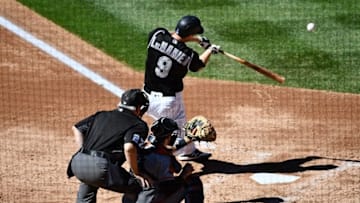 Sep 5, 2016; Denver, CO, USA; Colorado Rockies second baseman DJ LeMahieu (9) hits a sacrifice fly to score shortstop Cristhian Adames (not pictured) in the third inning against the San Francisco Giants at Coors Field. Mandatory Credit: Ron Chenoy-USA TODAY Sports