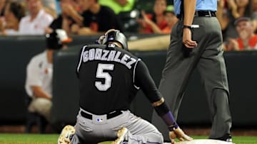 Jul 25, 2016; Baltimore, MD, USA; Colorado Rockies outfielder Carlos Gonzalez (5) reacts after being picked off in the seventh inning against the Baltimore Orioles at Oriole Park at Camden Yards. Mandatory Credit: Evan Habeeb-USA TODAY Sports
