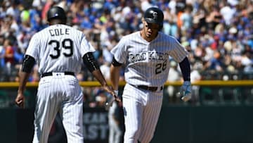 Aug 21, 2016; Denver, CO, USA; Colorado Rockies third baseman Nolan Arenado (28) celebrates his three run home run with third base coach Stu Cole (39) in the first inning against the Chicago Cubs at Coors Field. Mandatory Credit: Ron Chenoy-USA TODAY Sports