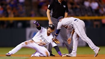 DENVER, CO - JULY 24: Carlos Gonzalez #5 of the Colorado Rockies reacts after his RBI double during the seventh inning as Marwin Gonzalez #9 of the Houston Astros applies a late tag and umpire Jordan Baker #71 looks on during interleague play at Coors Field on July 24, 2018 in Denver, Colorado. (Photo by Justin Edmonds/Getty Images)