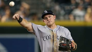 PHOENIX, AZ - JULY 20: Pat Valaika #4 of the Colorado Rockies throws to first base during the ninth inning of an MLB game against the Arizona Diamondbacks at Chase Field on July 20, 2018 in Phoenix, Arizona. (Photo by Ralph Freso/Getty Images)