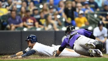 MILWAUKEE, WI - AUGUST 04: Hernan Perez #14 of the Milwaukee Brewers beats a tag at home by Chris Iannetta #22 of the Colorado Rockies during the sixth inning of a game at Miller Park on August 4, 2018 in Milwaukee, Wisconsin. (Photo by Stacy Revere/Getty Images)