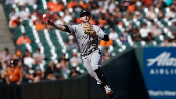 SAN FRANCISCO, CA - SEPTEMBER 16: Trevor Story #27 of the Colorado Rockies throws to first base to get the out of Brandon Crawford #35 of the San Francisco Giants in the bottom of the eighth inning at AT&T Park on September 16, 2018 in San Francisco, California. (Photo by Lachlan Cunningham/Getty Images)