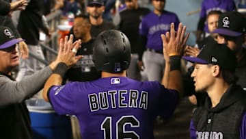 LOS ANGELES, CA - SEPTEMBER 17: Drew Butera #16 of the Colorado Rockies celebrates in the dugout with teammates after scoring during the eighth inning of the MLB game against the Los Angeles Dodgers at Dodger Stadium on September 17, 2018 in Los Angeles, California. (Photo by Victor Decolongon/Getty Images)