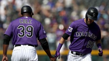 DENVER, CO - SEPTEMBER 27: David Dahl #26 of the Colorado Rockies is congraulated by third base coach Stu Cole #39 as he circles the bases after hitting a home run in the first inning against the Philadelphia Phillies at Coors Field on September 27, 2018 in Denver, Colorado. (Photo by Matthew Stockman/Getty Images)