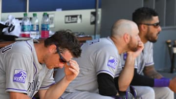 LOS ANGELES, CA - OCTOBER 01: DJ LeMahieu #9; Chris Iannetta #22 and Ian Desmond #20 of the Colorado Rockies sit in the dugout during the eighth inning of the game against the Los Angeles Dodgers at Dodger Stadium on October 1, 2018 in Los Angeles, California. (Photo by Jayne Kamin-Oncea/Getty Images)