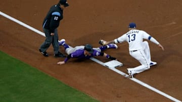 SAN DIEGO, CALIFORNIA - APRIL 16: Trevor Story #27 of the Colorado Rockies safely steals third base as Manny Machado #13 of the San Diego Padres places a late tag during the third inning of a game at PETCO Park on April 16, 2019 in San Diego, California. (Photo by Sean M. Haffey/Getty Images)