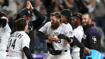 DENVER, COLORADO - APRIL 19: Charlie Blackmon #19 of the Colorado Rockies celebrates with Tony Wolters #14 and Ian Desmond #20 after hitting a 2 RBI walk off home run in the 12th inning against the Philadelphia Phillies at Coors Field on April 19, 2019 in Denver, Colorado. (Photo by Matthew Stockman/Getty Images)