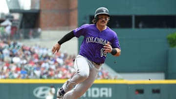 ATLANTA, GEORGIA - APRIL 28: Tony Wolters #14 of the Colorado Rockies rounds third base en route to scoring in the third inning against the Atlanta Braves at SunTrust Park on April 28, 2019 in Atlanta, Georgia. (Photo by Logan Riely/Getty Images)