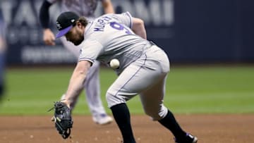 MILWAUKEE, WISCONSIN - MAY 01: Daniel Murphy #9 of the Colorado Rockies misplays a ground ball in the fourth inning against the Milwaukee Brewers at Miller Park on May 01, 2019 in Milwaukee, Wisconsin. (Photo by Dylan Buell/Getty Images)