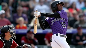 DENVER, COLORADO - MAY 05: Raimel Tapia the Colorado Rockies hits a 3 RBI triple in the eighth inning against the Arizona Diamondbacks at Coors Field on May 05, 2019 in Denver, Colorado. (Photo by Matthew Stockman/Getty Images)