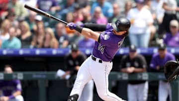 DENVER, COLORADO - MAY 30: Tony Wolters #14 of the Colorado Rockies hits a RBI sacrifice fly in the first inning against the Arizona Diamondbacks at Coors Field on May 30, 2019 in Denver, Colorado. (Photo by Matthew Stockman/Getty Images)