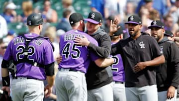 CHICAGO, ILLINOIS - JUNE 06: Scott Oberg #45 of the Colorado Rockies gets a hug from Peter Lambert #23 following their team's 3-1 win over the Chicago Cubs at Wrigley Field on June 06, 2019 in Chicago, Illinois. (Photo by Nuccio DiNuzzo/Getty Images)