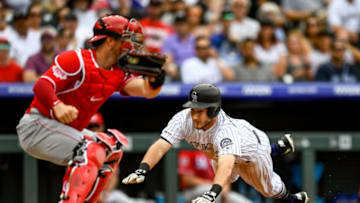 DENVER, CO - JULY 14: Garrett Hampson #1 of the Colorado Rockies dives to score a fifth inning run ahead of a tag attempt by Kyle Farmer #52 of the Cincinnati Reds at Coors Field on July 14, 2019 in Denver, Colorado. (Photo by Dustin Bradford/Getty Images)