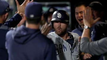DENVER, COLORADO - JUNE 14: Austin Allen #62 of the San Diego Padres celebrates in the dugout after scoring on a Many Machado double in the 12th inning against the Colorado Rockies at Coors Field on June 14, 2019 in Denver, Colorado. (Photo by Matthew Stockman/Getty Images)