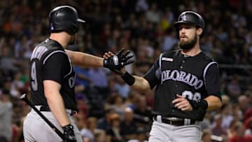 PHOENIX, ARIZONA - JUNE 18: David Dahl #26 of the Colorado Rockies is congratulated by Daniel Murphy #9 after scoring in the sixth inning of a MLB game against the Arizona Diamondbacks at Chase Field on June 18, 2019 in Phoenix, Arizona. (Photo by Jennifer Stewart/Getty Images)
