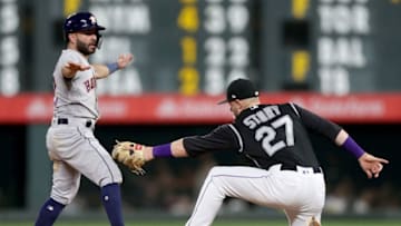 DENVER, COLORADO - JULY 02: Jose Altuve #27of the Houston Astros steals second base in the ninth inning against Trevor Story #27 of the Colorado Rockies at Coors Field on July 02, 2019 in Denver, Colorado. (Photo by Matthew Stockman/Getty Images)