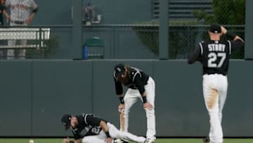 DENVER, COLORADO - AUGUST 02: David Dahl #26 of the Colorado Rockies is injured in the sixth inning against the San Francisco Giants at Coors Field on August 02, 2019 in Denver, Colorado. (Photo by Matthew Stockman/Getty Images)