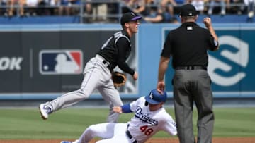 LOS ANGELES, CA - SEPTEMBER 22: Ryan McMahon #24 of the Colorado Rockies catches Gavin Lux #48 of the Los Angeles Dodgers in a double play at second base in the first inning at Dodger Stadium on September 22, 2019 in Los Angeles, California. (Photo by John McCoy/Getty Images)