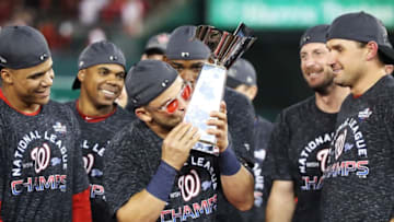 WASHINGTON, DC - OCTOBER 15: Gerardo Parra #88 of the Washington Nationals celebrates with the trophy after winning game four and the National League Championship Series against the St. Louis Cardinals at Nationals Park on October 15, 2019 in Washington, DC. (Photo by Rob Carr/Getty Images)