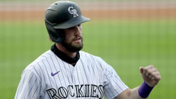 DENVER, COLORADO - AUGUST 04: David Dahl #26 of the Colorado Rockies celebrates after scoring on a sacrifice fly by Charlie Blackmon #19 in the first inning against the San Francisco Giants at Coors Field on August 04, 2020 in Denver, Colorado. (Photo by Matthew Stockman/Getty Images)