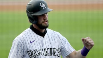 DENVER, COLORADO - AUGUST 04: David Dahl #26 of the Colorado Rockies celebrates after scoring on a sacrifice fly by Charlie Blackmon #19 in the first inning against the San Francisco Giants at Coors Field on August 04, 2020 in Denver, Colorado. (Photo by Matthew Stockman/Getty Images)