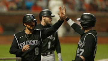 SAN FRANCISCO, CALIFORNIA - SEPTEMBER 21: Josh Fuentes #8 of the Colorado Rockies celebrates with Trevor Story #27 after they both scored on a two-run single by Elias Diaz #35 in the top of the fifth inning against the San Francisco Giants at Oracle Park on September 21, 2020 in San Francisco, California. (Photo by Lachlan Cunningham/Getty Images)