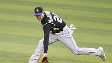 MIAMI, FLORIDA - JUNE 08: Ryan McMahon #24 of the Colorado Rockies fields a ground ball against the Miami Marlins during the first inning at loanDepot park on June 08, 2021 in Miami, Florida. (Photo by Michael Reaves/Getty Images)