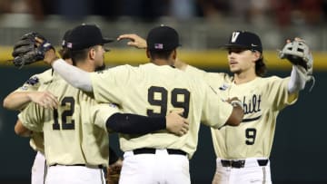 OMAHA, NEBRASKA - JUNE 28: Carter Young #9, Jayson Gonzalez #99 and Dominic Keegan #12 of the Vanderbilt celebrate after defeating the Mississippi St. Bulldogs 8-2 in game one of the College World Series Championship at TD Ameritrade Park Omaha on June 28, 2021 in Omaha, Nebraska. (Photo by Sean M. Haffey/Getty Images)