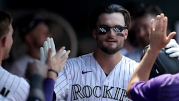DENVER, COLORADO - AUGUST 05: Sam Hilliard #22 of the Colorado Rockies celebrates in the dugout after hitting a solo home run against the Chicago Cubs in the fourth inning at Coors Field on August 05, 2021 in Denver, Colorado. (Photo by Matthew Stockman/Getty Images)