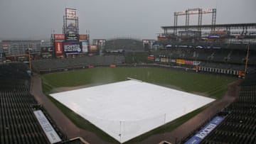 DENVER, CO - MAY 23: The tarp covers the infield as rain and hail fall delaying the start of the first game of a doubleheader between the San Francisco Giants and the Colorado Rockies at Coors Field on May 23, 2015 in Denver, Colorado. (Photo by Doug Pensinger/Getty Images)
