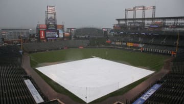 DENVER, CO - MAY 23: The tarp covers the infield as rain and hail fall delaying the start of the first game of a doubleheader between the San Francisco Giants and the Colorado Rockies at Coors Field on May 23, 2015 in Denver, Colorado. (Photo by Doug Pensinger/Getty Images)