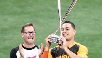 SAN DIEGO, CA - JULY 11: Giancarlo Stanton of the Miami Marlins is presented the winner's trophy by Mike Sievert, Chief Operating Officer of T-Mobile, after winning the T-Mobile Home Run Derby at PETCO Park on July 11, 2016 in San Diego, California. (Photo by Denis Poroy/Getty Images)