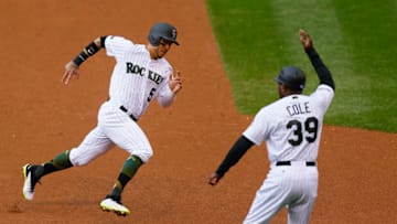 DENVER, CO - MAY 29: Third base coach Stu Cole waves Carlos Gonzalez #5 of the Colorado Rockies threw as he rounds third base on his way to scoring in the fourth inning against the Seattle Mariners during interleague play at Coors Field on May 29, 2017 in Denver, Colorado. (Photo by Justin Edmonds/Getty Images)