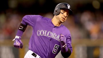 DENVER, CO - JULY 18: Carlos Gonzalez #5 of the Colorado Rockies scores on a Alexi Amarista RBI single in the fifth inning against the San Diego Padres at Coors Field on July 18, 2017 in Denver, Colorado. (Photo by Matthew Stockman/Getty Images)