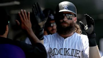 DENVER, CO - JULY 19: Charlie Blackmon #19 of the Colorado Rockies is congratulated in the dugout after scoring on a Nolan Arenado RBI single in the first inning against the San Diego Padres at Coors Field on July 19, 2017 in Denver, Colorado. (Photo by Matthew Stockman/Getty Images)