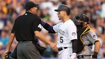DENVER, CO - JULY 22: Carlos Gonzalez #5 of the Colorado Rockies is restrained from going to the mound by home plate umpire Chad Fairchild in the sixth inning against the Pittsburgh Pirates at Coors Field on July 22, 2017 in Denver, Colorado. (Photo by Matthew Stockman/Getty Images)