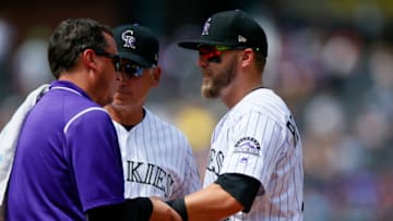 DENVER, CO - AUGUST 20: First baseman Mark Reynolds #12 of the Colorado Rockies is looked at by the trainer after injuring himself on a play during the fourth inning as Manager Bud Black of the Colorado Rockies looks on against the Milwaukee Brewers at Coors Field on August 20, 2017 in Denver, Colorado. (Photo by Justin Edmonds/Getty Images)