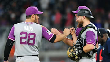 ATLANTA, GA - AUGUST 26: Nolan Arenado #28, Jake McGee #51 (obscured), and,Jonathan Lucroy #21 of the Colorado Rockies celebrate after the game against the Atlanta Braves at SunTrust Park on August 26, 2017 in Atlanta, Georgia. (Photo by Scott Cunningham/Getty Images)