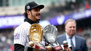DENVER, CO - APRIL 06: Nolan Arenado of the Colorado Rockies receives the Rawlings Gold Glove and Platinum Glove Award before the Rockies home opener against the Atlanta Braves at Coors Field on April 6, 2018 in Denver, Colorado. (Photo by Matthew Stockman/Getty Images)
