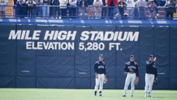 DENVER - APRIL 15: Colorado Rockies players stand in the outfield with at Mile High Stadium elevation sign in background before the game against the New York Mets on April 15, 1993 in Denver, Colorado. (Photo by Tim DeFrisco/Getty Images)