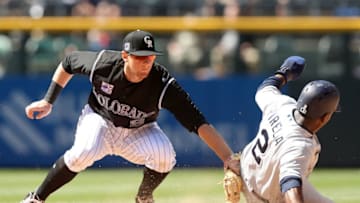 DENVER, CO - APRIL 25: D.J. LeMahieu #9 of the Colorado Rockies tags out Jose Pirela #2 of the San Diego Padres trying to score in the sixth inning at Coors Field on April 25, 2018 in Denver, Colorado. (Photo by Matthew Stockman/Getty Images)