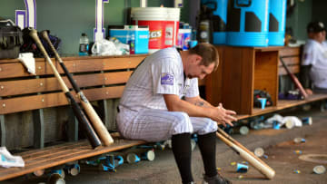 DENVER, CO - JUNE 02: Bryan Shaw #29 of the Colorado Rockies hangs his head in the dugout after being pulled after pitching 1/3 inning and allowing 3 runs in the seventh inning of a game against the Los Angeles Dodgers at Coors Field on June 2, 2018 in Denver, Colorado. (Photo by Dustin Bradford/Getty Images)
